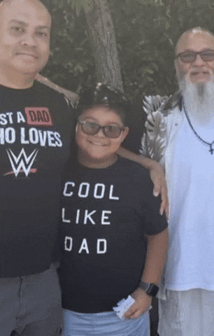 a boy wearing a shirt that says cool like dad poses for a picture