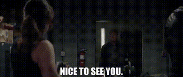 a woman is standing in front of a man and says nice to see you