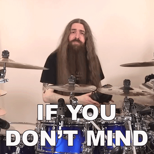 a man with long hair and a beard playing drums with the words " if you don 't mind " above him