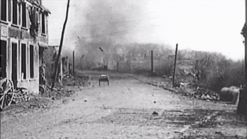 a black and white photo of a destroyed town street