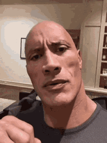 Dwayne Johnson points toward the camera with a questioning expression.