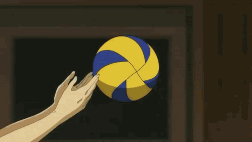 a volleyball player with the number 12 on his back jumps over the net