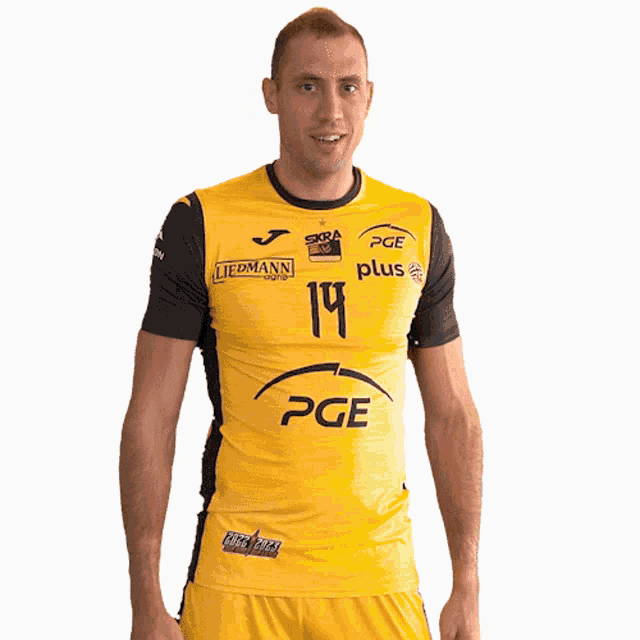 a man wearing a yellow pge plus jersey