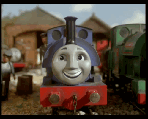 a blue and red train with a smiling face on the front
