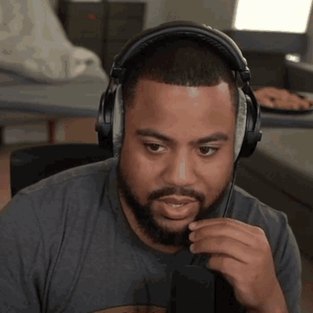 a man with a beard is wearing headphones