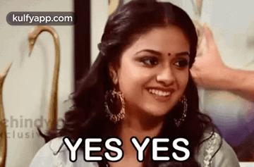 a woman is smiling with the words `` yes yes '' on her face .