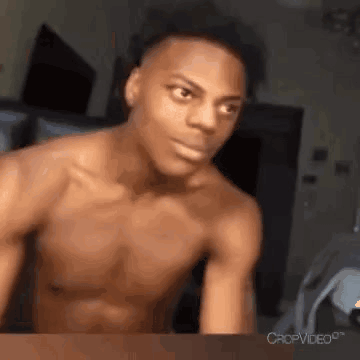 Shirtless man gestures energetically toward the camera.