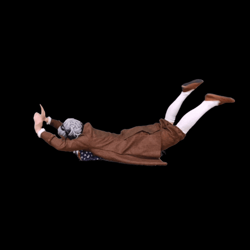 A person flops horizontally through a black background like doing the worm.
