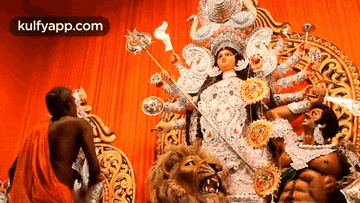 a statue of a woman holding a torch is surrounded by a lion and a man .
