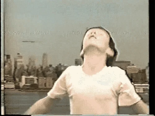A child throws their head back and dances energetically.