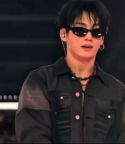 Jungkook wears dark sunglasses and a black jacket.