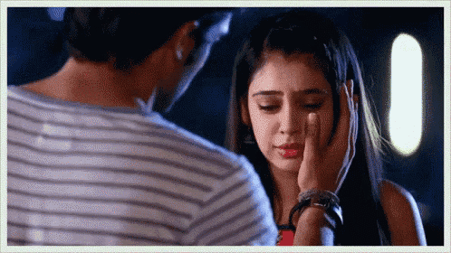 a man is touching a woman 's face and she is crying