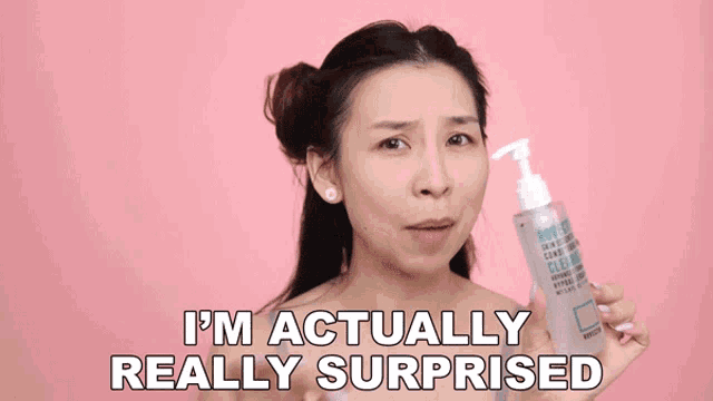 a woman is holding a bottle of body cleanser and saying i 'm actually really surprised