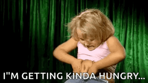 A little girl holds her stomach under “I’M GETTING KINDA HUNGRY…”
