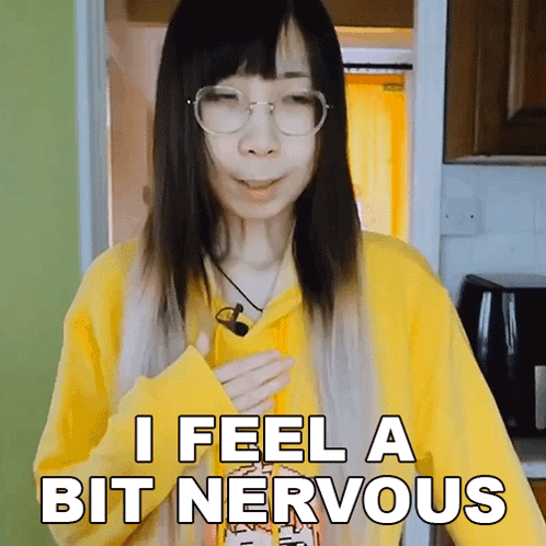 A woman in a yellow shirt says, “I FEEL A BIT NERVOUS.”