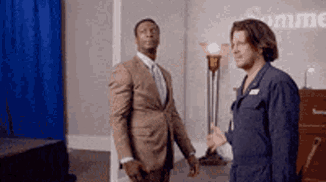 Two suited men begin a secret handshake.