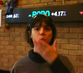 a woman making a face in front of a sign that says ' pppo + 4.17% '