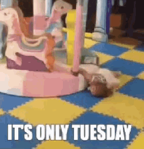 a child laying on the floor with the words it 's only tuesday above it