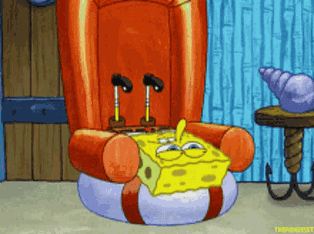 SpongeBob slumps down in an armchair with a bored expression.