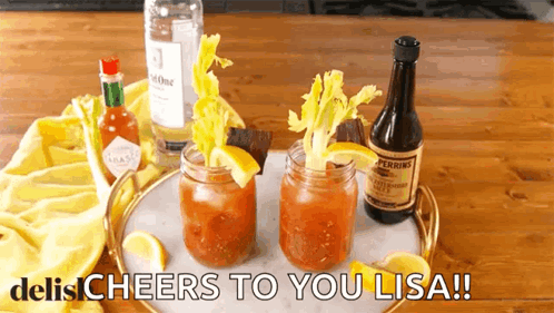two bloody marys are on a tray with the words cheers to you lisa