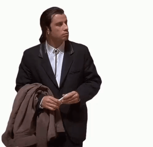 John Travolta stands alone and looks around in confusion.