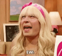 Jimmy Fallon in a pink headband and blonde wig reacts with a small “Ew” caption.