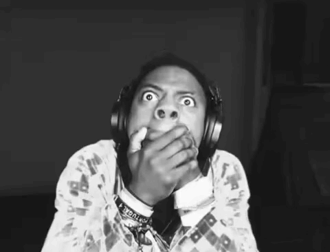 A streamer in black and white covers his mouth with a shocked stare.