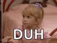 A young girl looks unimpressed beside a large “DUH” caption.