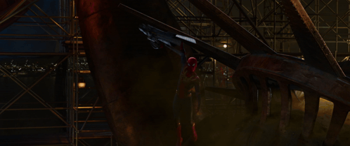 a spider man holding a gun in his hand