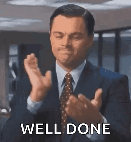 Leonardo DiCaprio slowly claps in a suit.