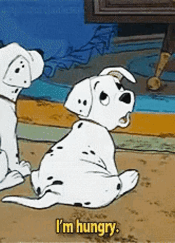 Two Dalmatian puppies look up with the caption “I’m hungry.”
