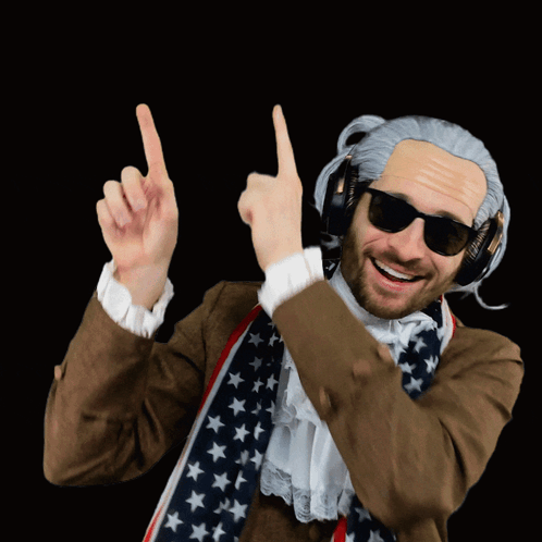 a man wearing a wig and sunglasses points upwards