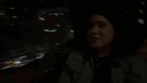 a woman in a dark room with the word not written in pink