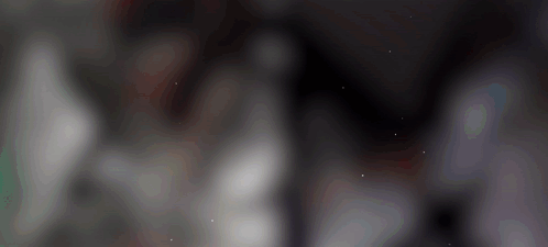 a blurred image of a dark background with a few white dots