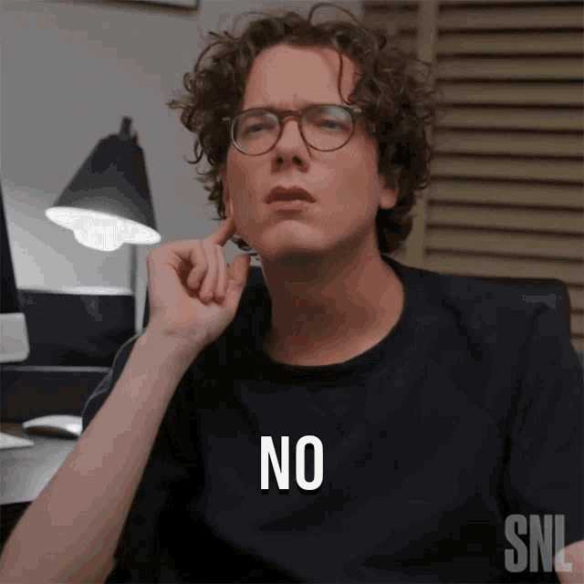a man wearing glasses and a black shirt that says no
