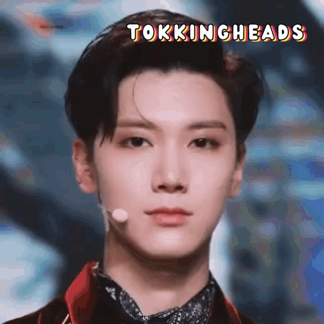 a close up of a man 's face with the words tokingheads written above him