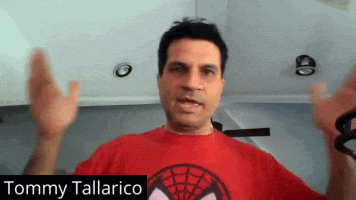 tommy tallarico is wearing a red shirt with a spider man logo on it