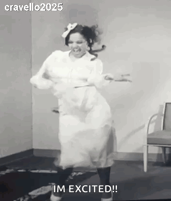 A woman in a white dress dances energetically in a black-and-white clip.