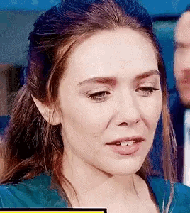 a close up of a woman 's face with her eyes closed .