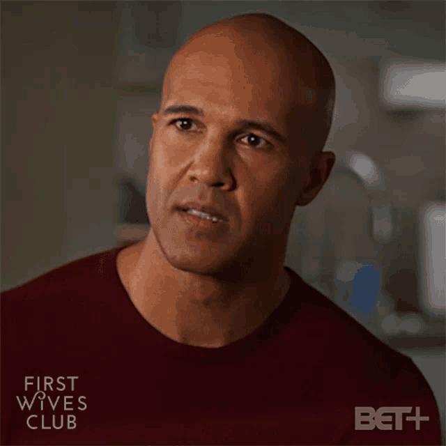 a man in a red shirt with the words first wives club on the bottom