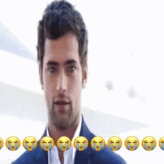 a man in a suit is smiling with tears coming from his eyes