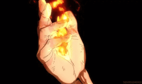 a close up of a person 's hand holding a piece of fire .
