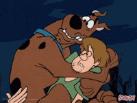 Scooby-Doo clutches Shaggy while both look frightened.