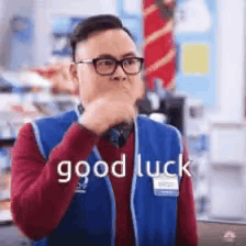 A man in glasses makes the sign of the cross beneath captions reading “good luck” and “YOU GOT THIS.”