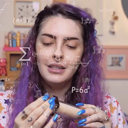 a woman with purple hair and blue nails is holding a chocolate bar in her hand .