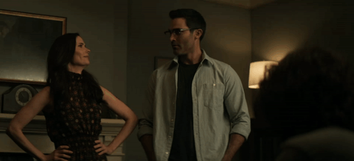 a man and a woman are standing in a living room
