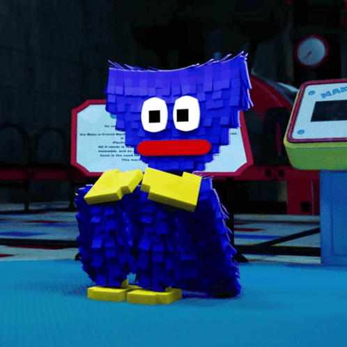 a blue cartoon character with a red nose is standing in front of a machine that says mar