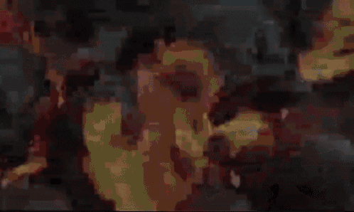 a bunch of skulls are sitting on top of a pile of coals .