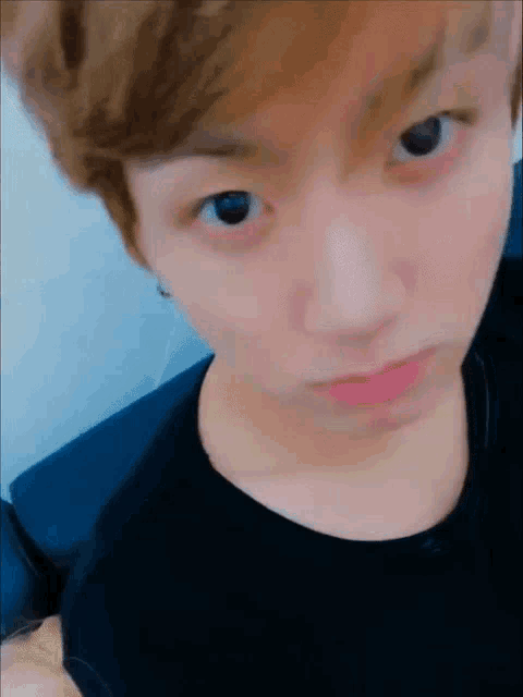 A young man gives the camera a quiet, intense stare.