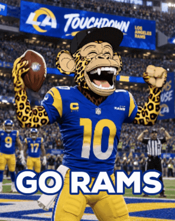 a rams mascot holding a football in front of a sign that says touchdown